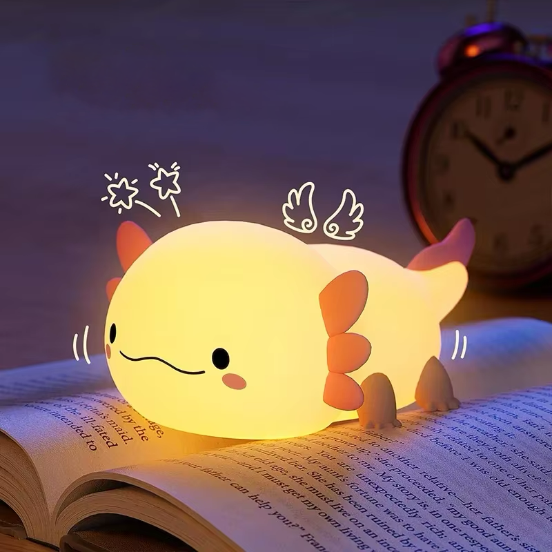 A cute axolotl-shaped lamp providing soft and warm light, ideal for bedside ambiance. Available at BlissfulGlow.