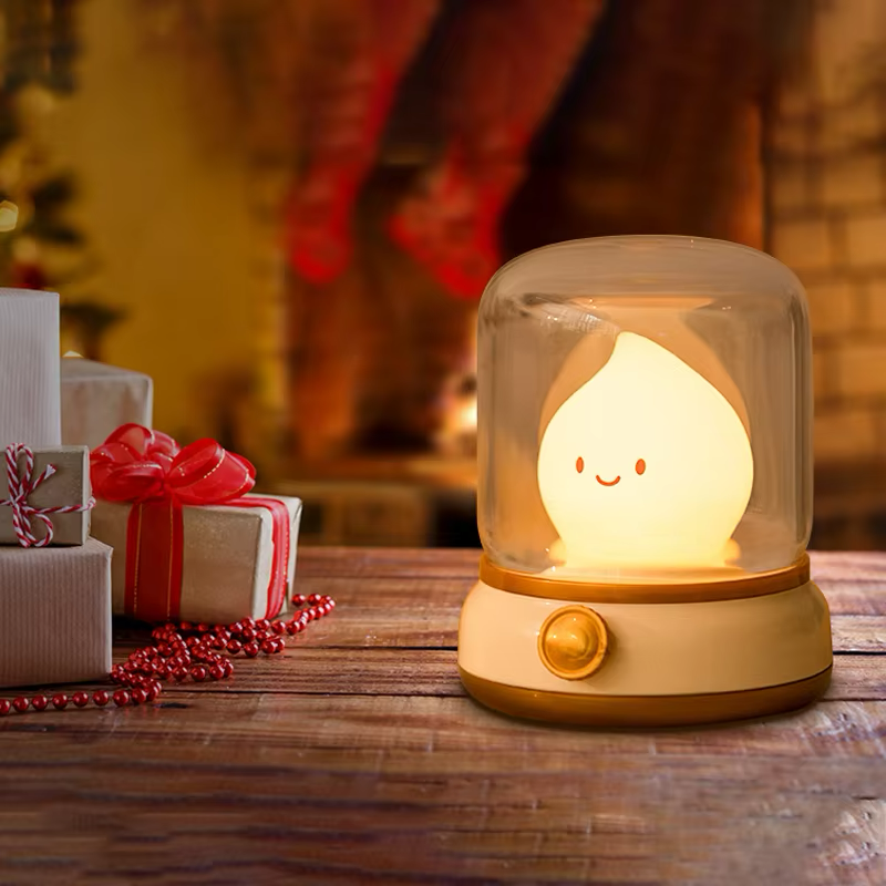 Flame-shaped night light in a glass dome, showcased in a festive Christmas setting with gifts and decorations, perfect for holiday ambiance, available at BlissfulGlow.