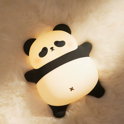 Soft glow panda night light lying on its back, perfect for a relaxing bedtime ambiance in your child's room. Available at BlissfulGlow.