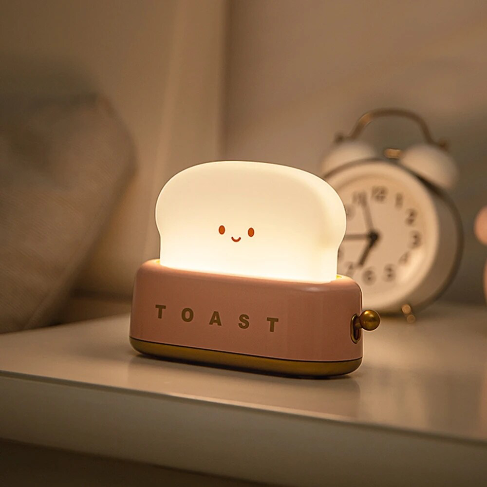 Soft pink toast night light, adding a touch of warmth and style to your room decor. Available at BlissfulGlow.